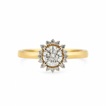Gold ring with a diamond center on a white background